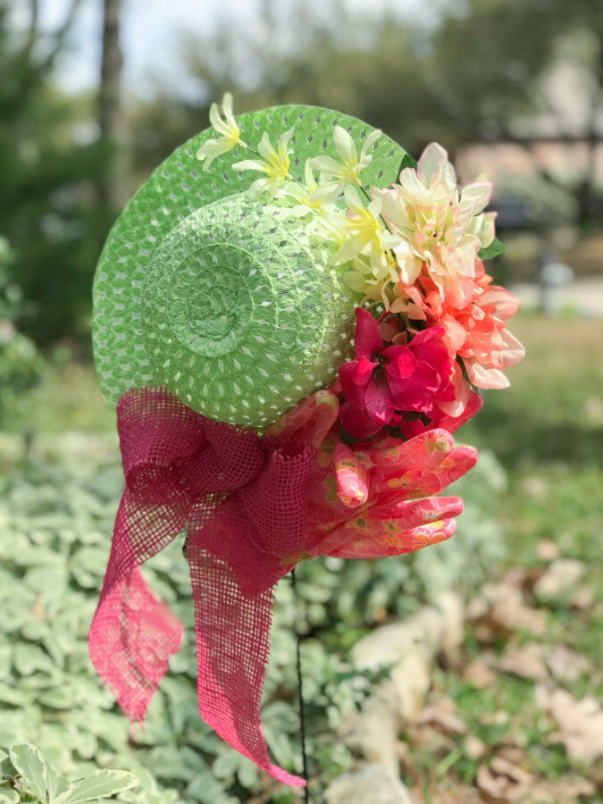 light green hat wreath with pink gloves, bow and flowers