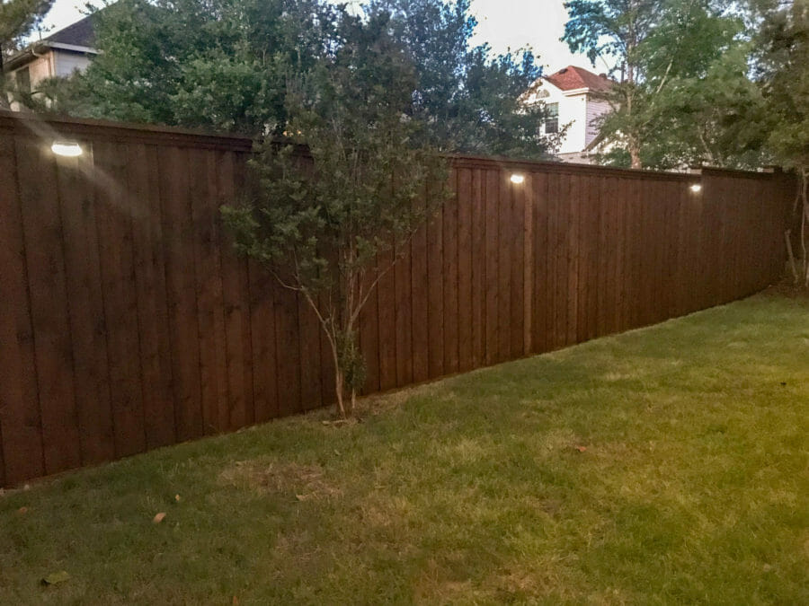 Lit up solar lights on fence