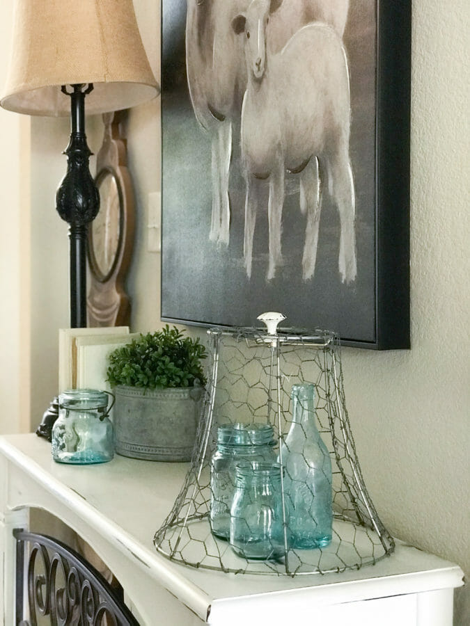 table with collection of blue bottles and artwork