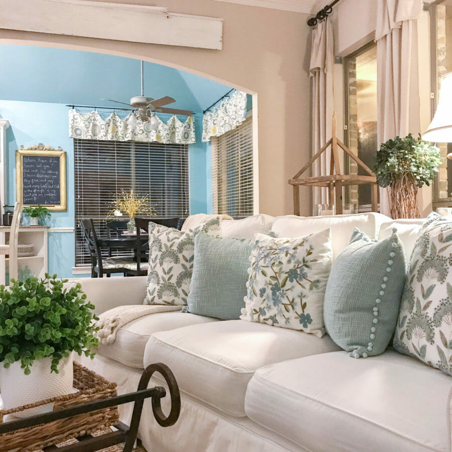 living room with white sofa and pillows