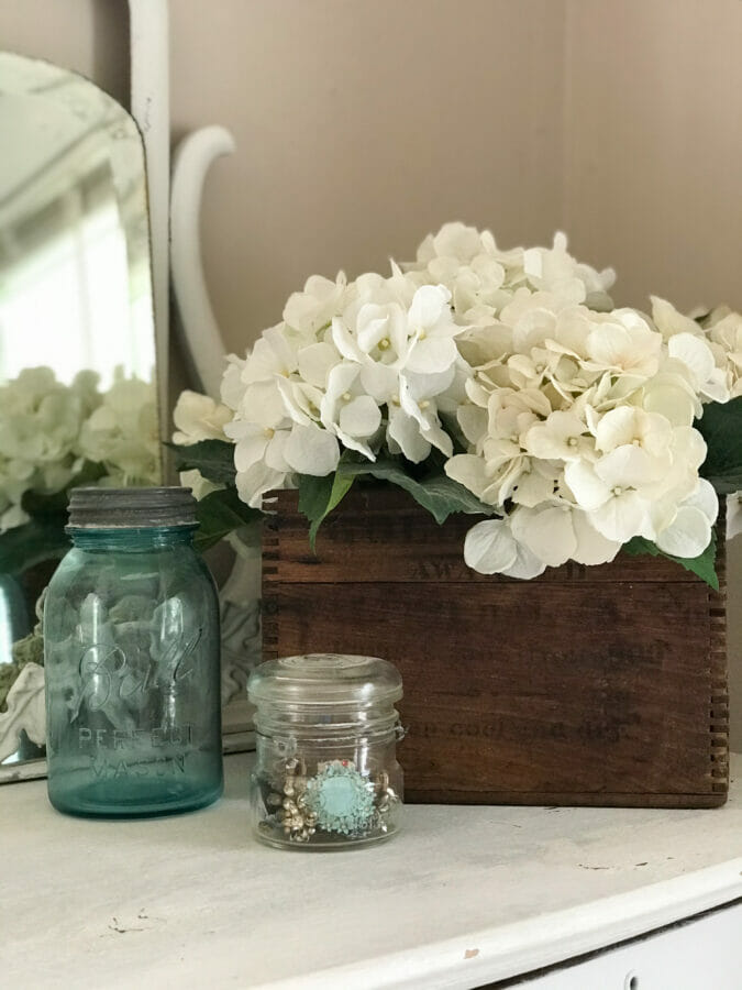 hydrangeas in wood box with jars