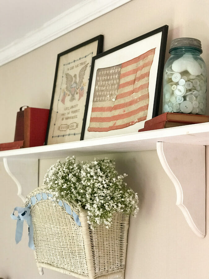 framed patriotic decor on shelf 