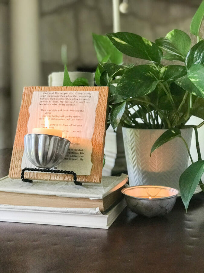 jello mold candle holder with book pages and plant