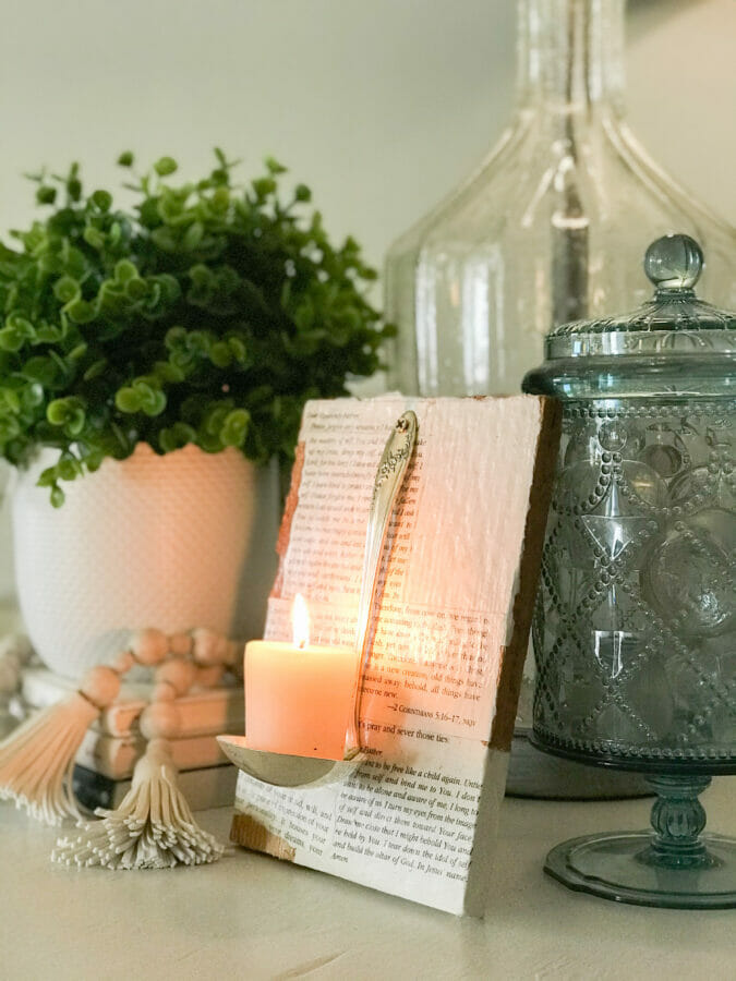 vintage ladle candle holder with book pages and accessories