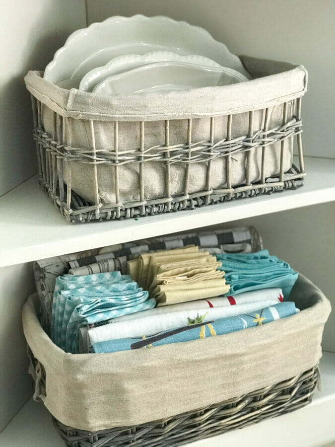 Baskets with linens and white dishes