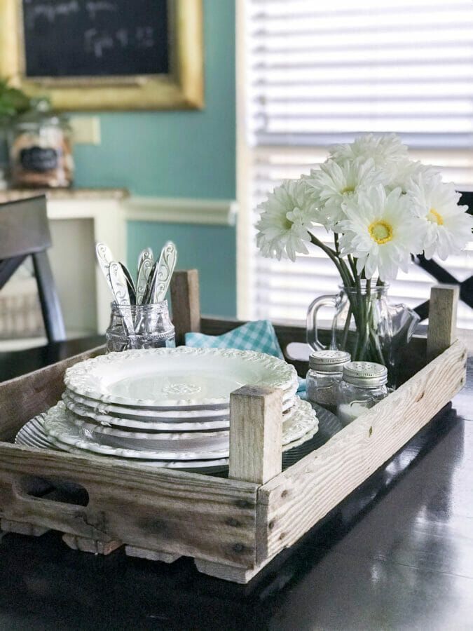 Crate on table with dishes and silverware