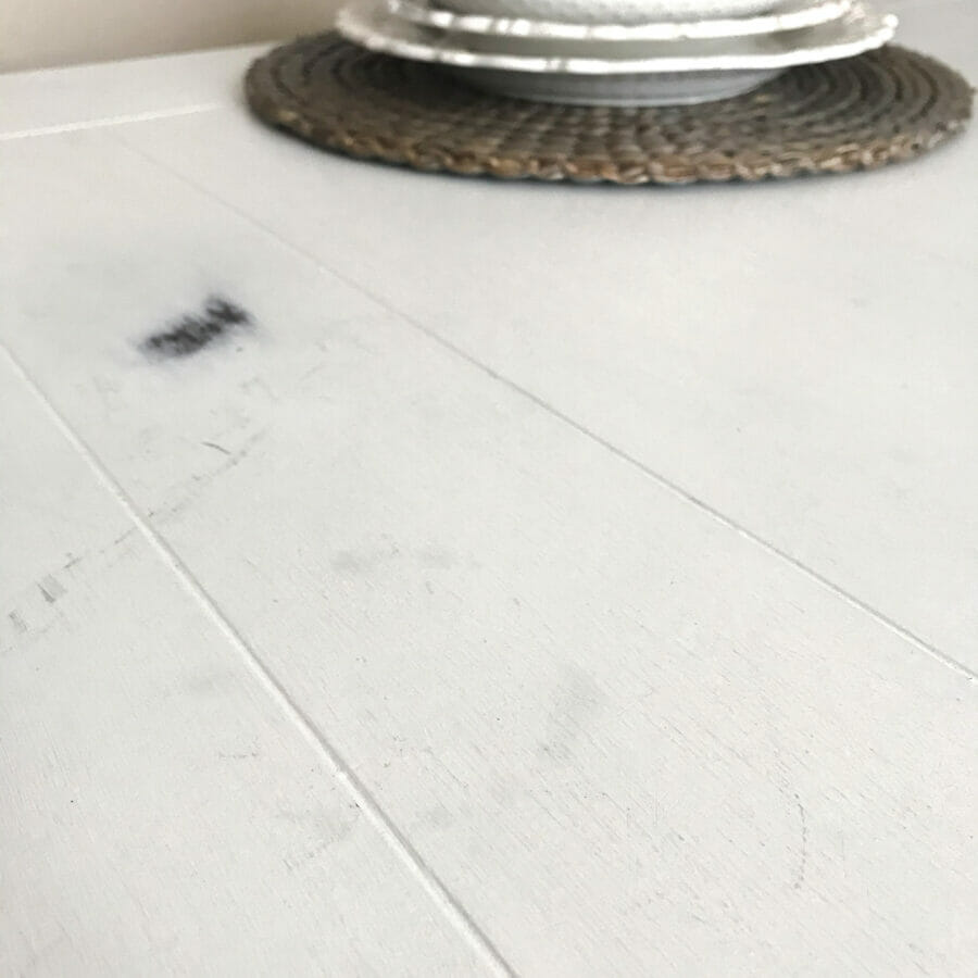 white planked dining table with scratches