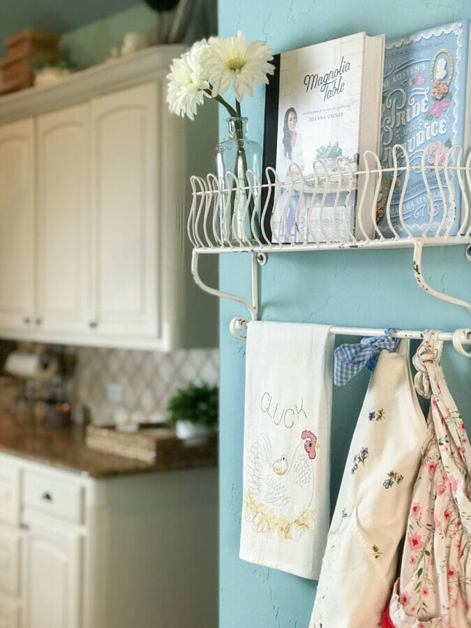 shelf with aprons and cookbooks