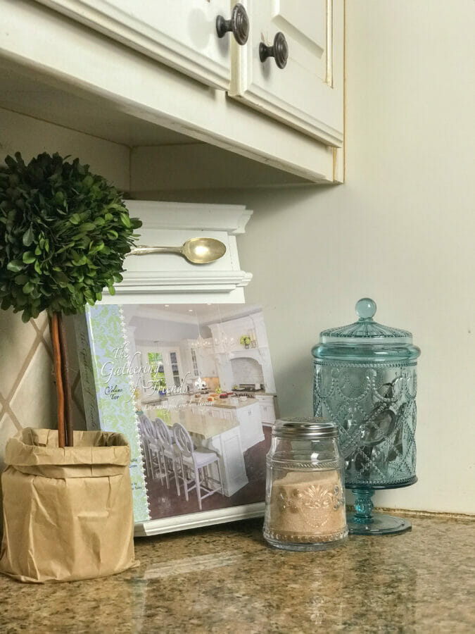 Redecorating with a cook book and blue canister
