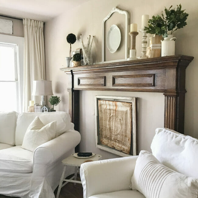 large mantel with seating and farmhouse items on top of mantel
