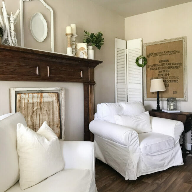 mantel with chairs, wall art and lamp