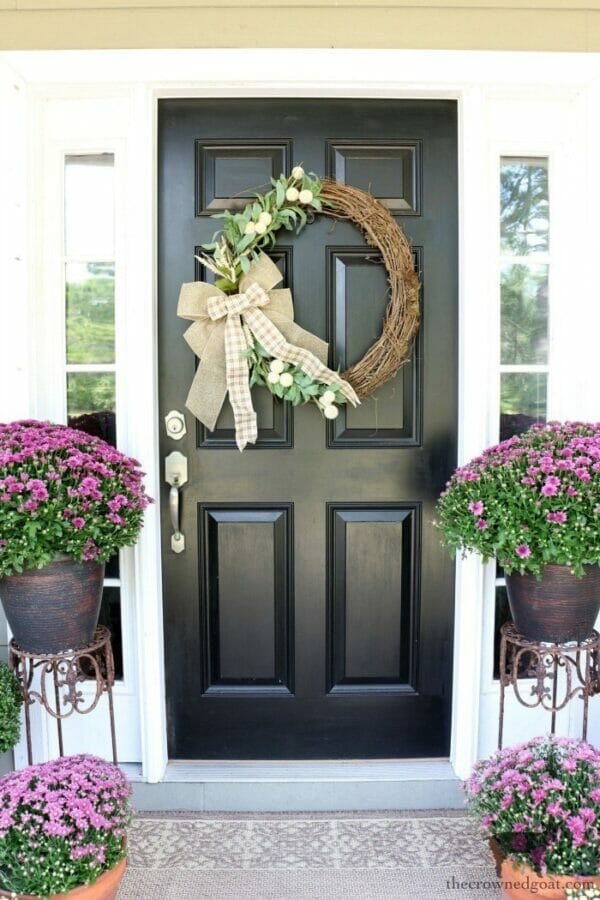 black front door with fall wreath