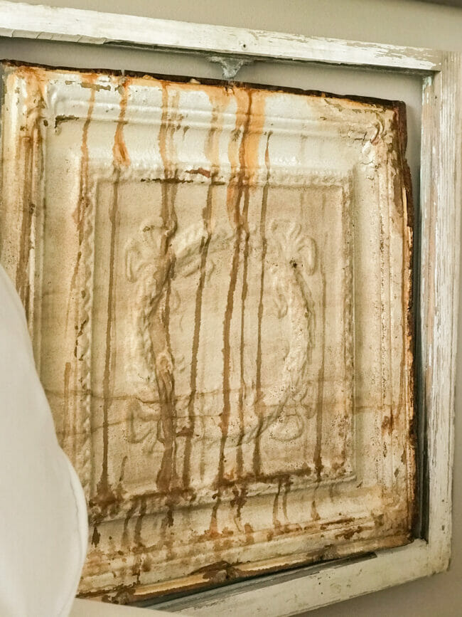 Vintage window with ceiling tin hanging inside