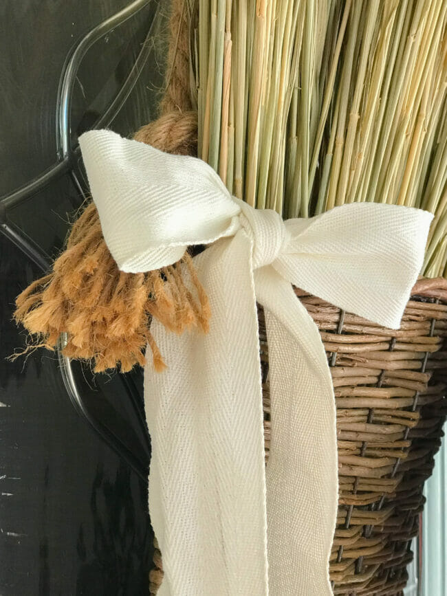 fabric bow with rope on hanging basket with wheat