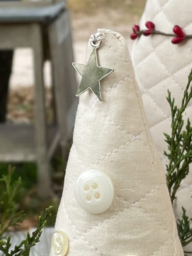 top of fabric tree with a button and silver star