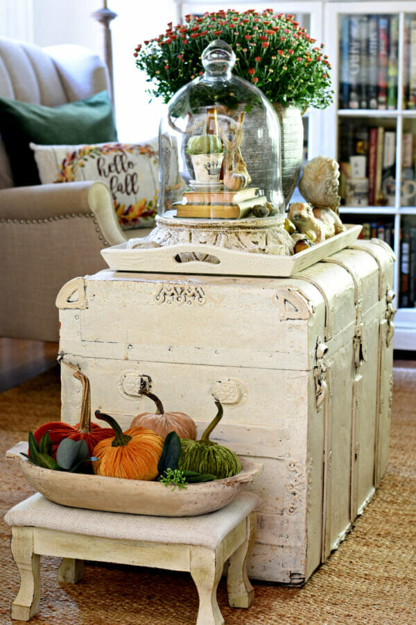 white trunk with pumpkins and cloche