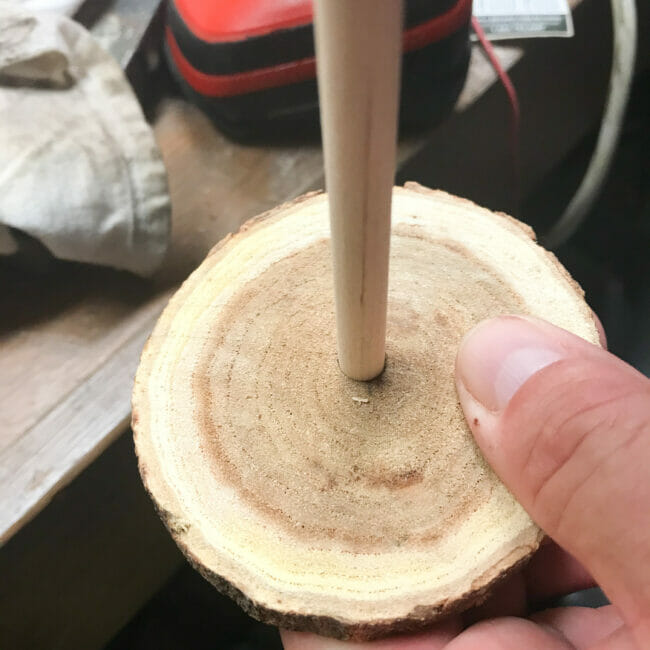 inserting rod into log slice