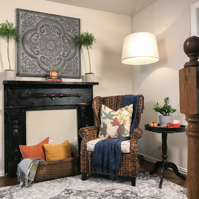inviting reading nook with black mantel, chair and side table