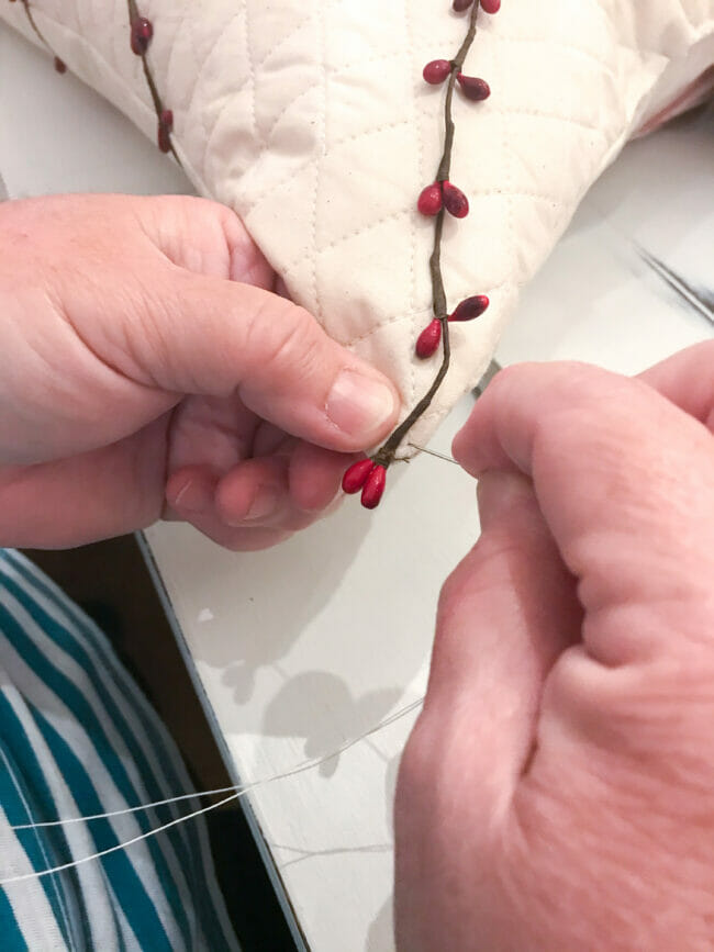 sewing wire garland on fabric tree