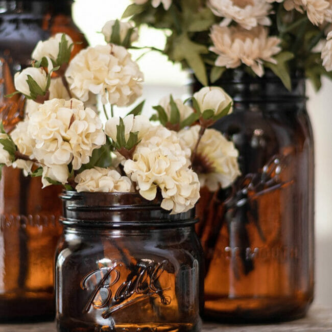 Amber bottles with flowers by the painted hinge