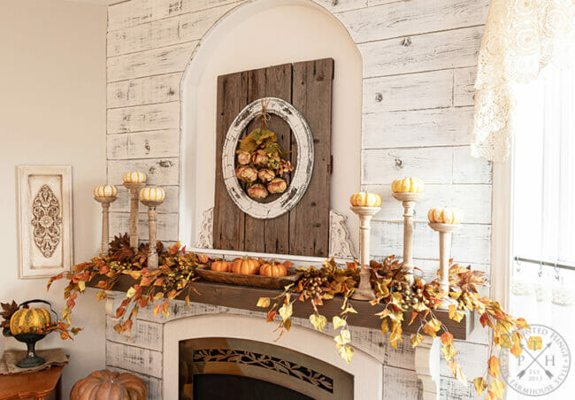 fall mantel with pumpkins and candlesticks