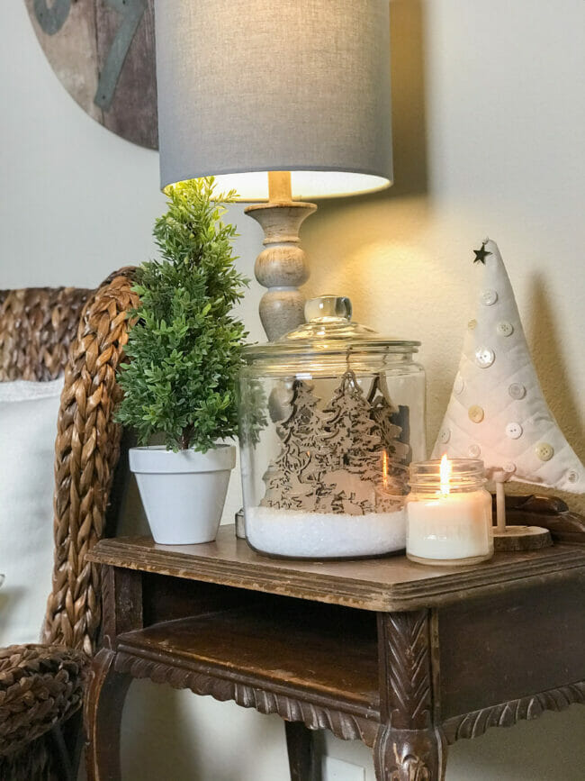 rattan chair with table and rustic jar, lamp and trees