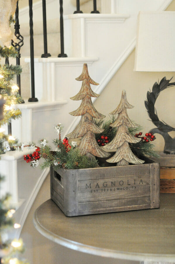 crate with wooden trees and garland