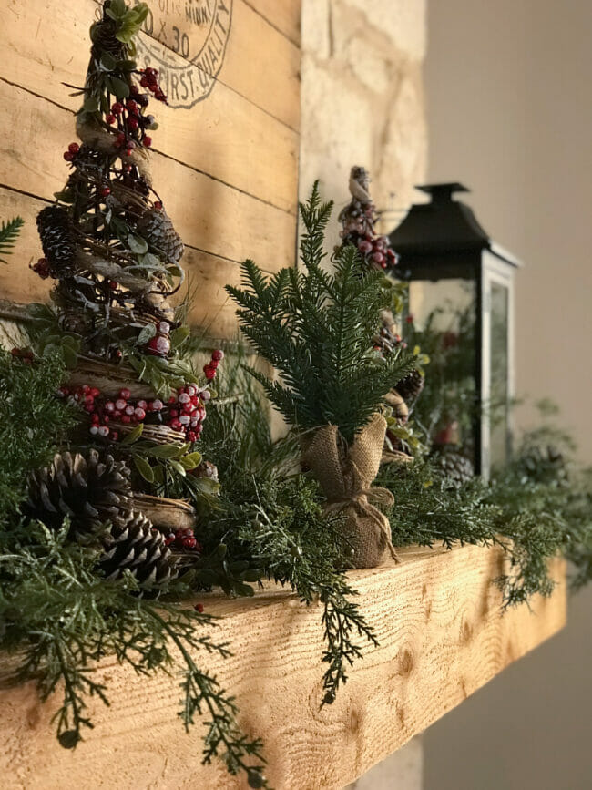 wood mantel with Christmas greens and lantern