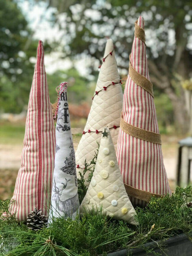 fabric trees in crate with fresh greenery