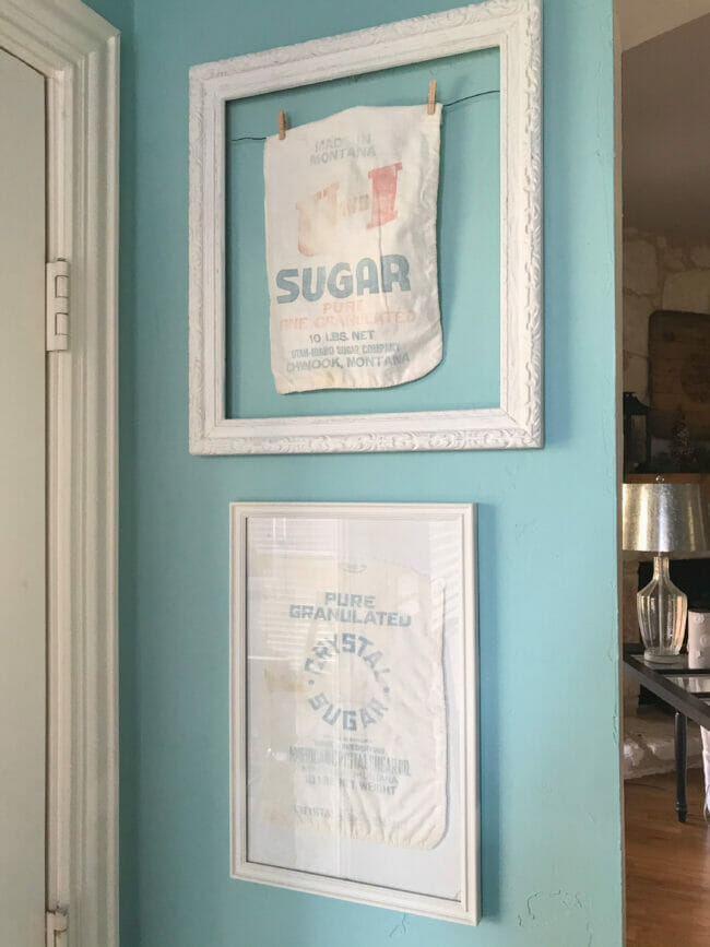 framed vintage sugar sacks on blue wall