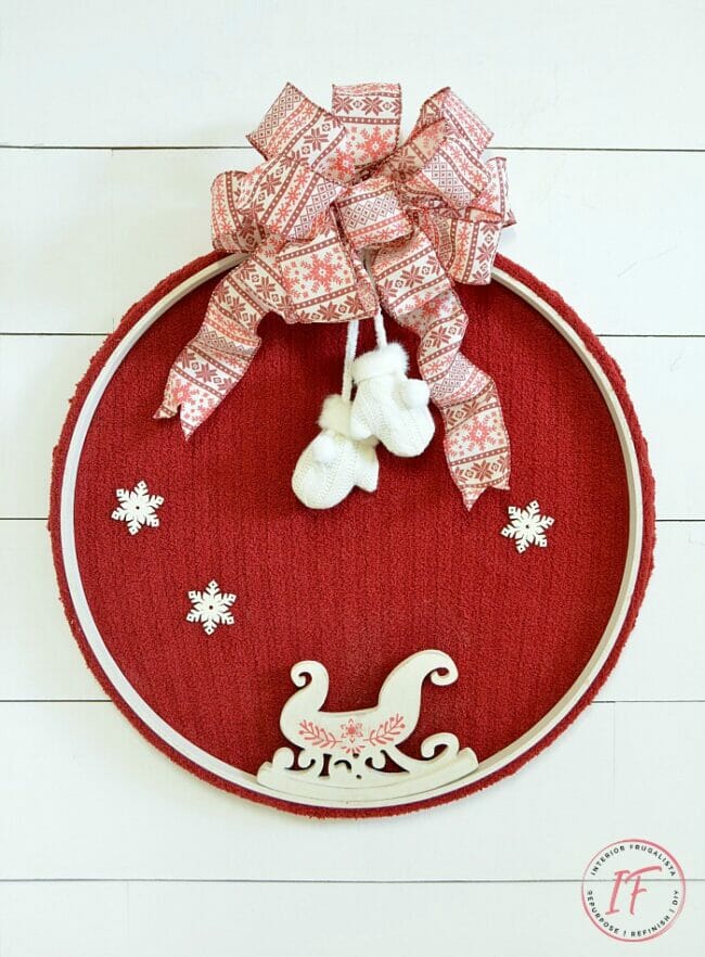 red wreath with sleigh and mittens
