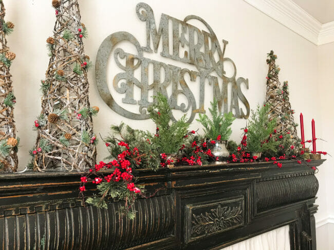 Merry Christmas galvanized sign over black mantel and light up twig cones
