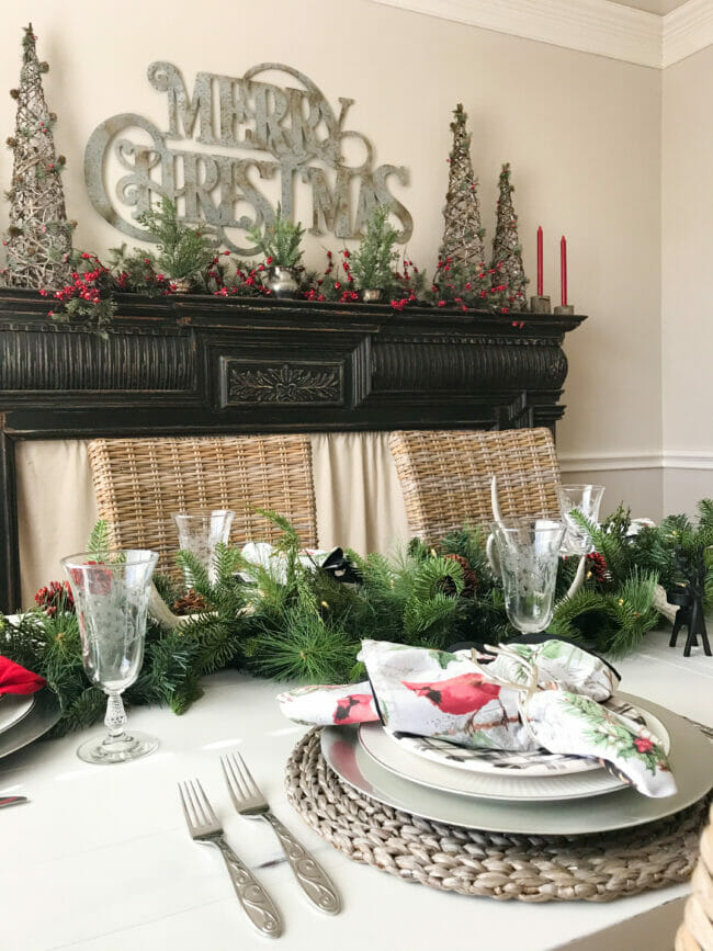 black mantel and dining table with garland and place setting