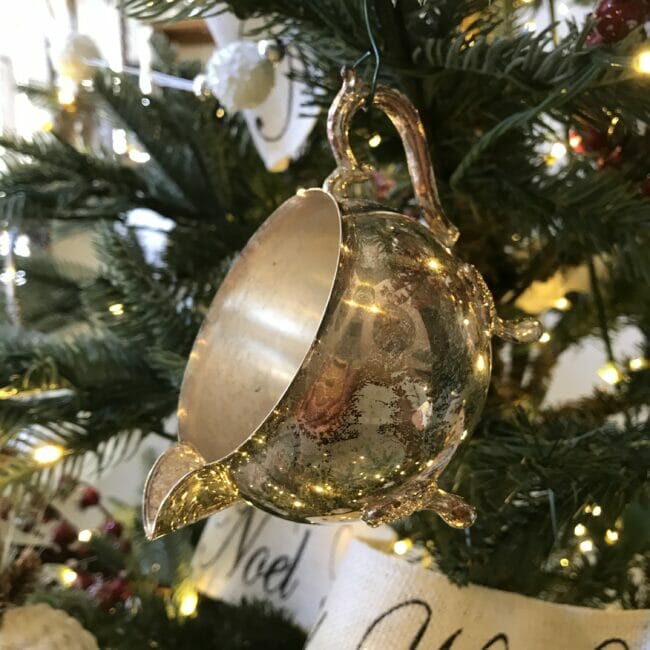 Vintage silver creamer at night on tree