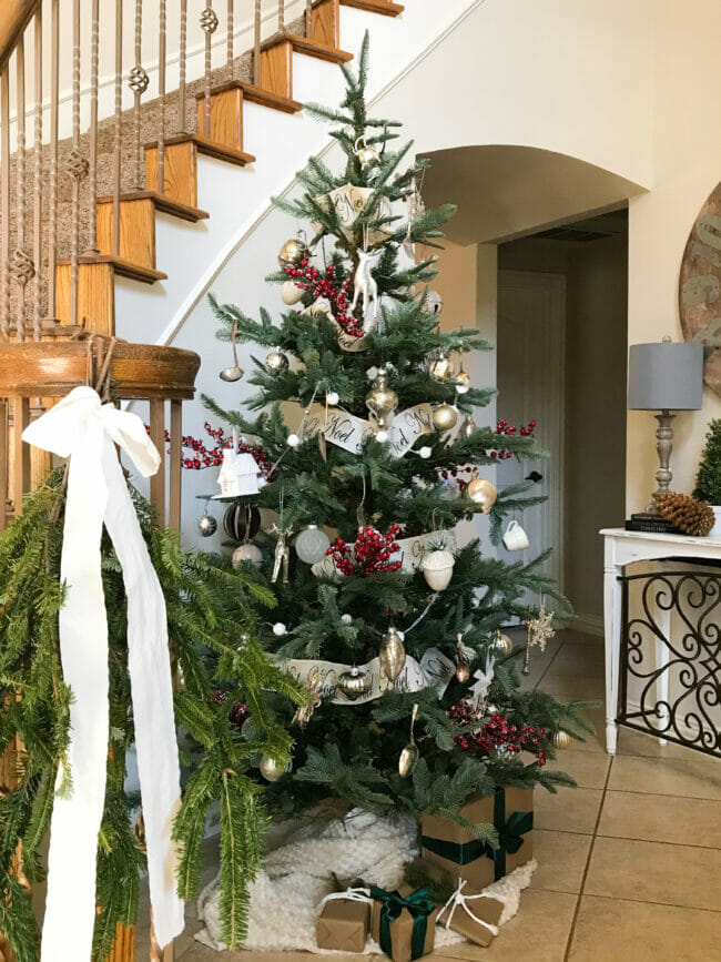 Christmas tree in front of stairs 