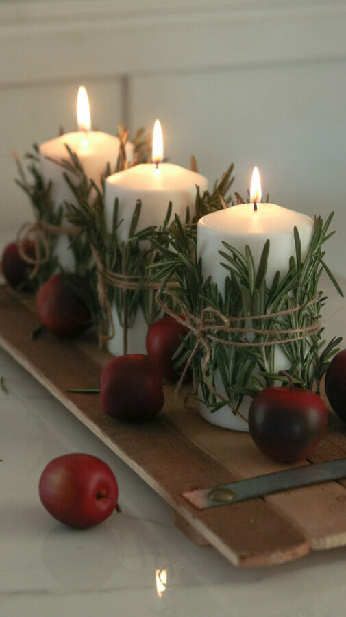 white candles wrapped with rosemary and twine