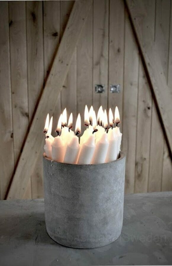 bucket with several lit white candles inside