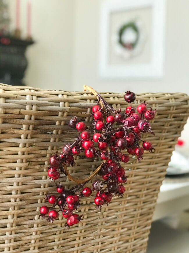 red cranberry wreath hanging on back of chair