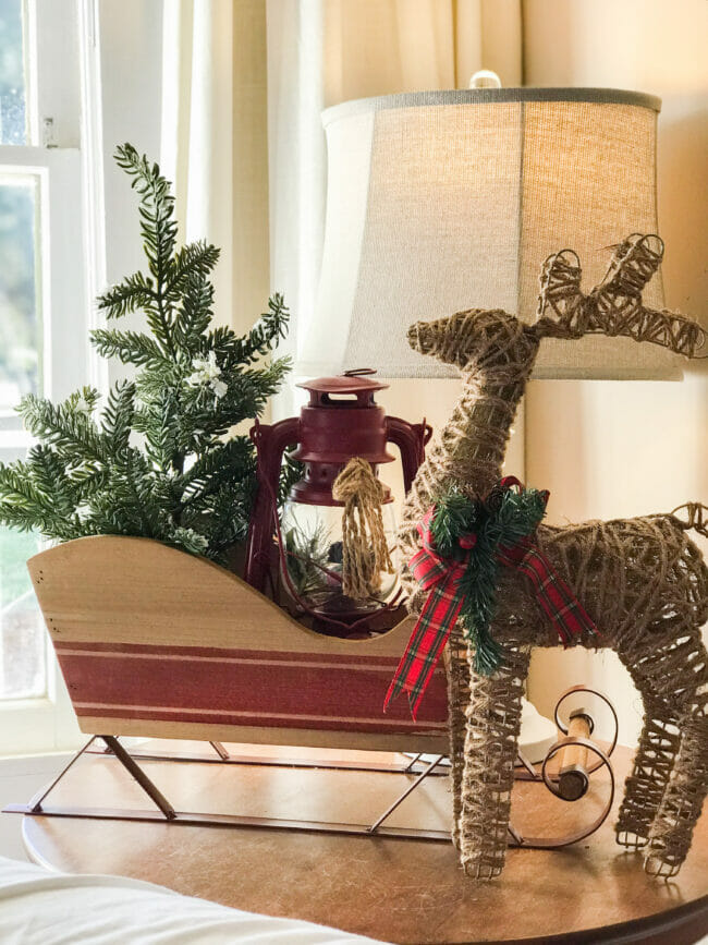 wooden sleigh with tree, lantern and reindeer