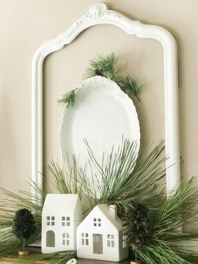 white platter with mirror frame and greenery