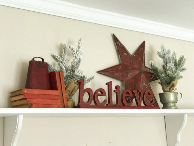 shelf with the word believe and a star with books