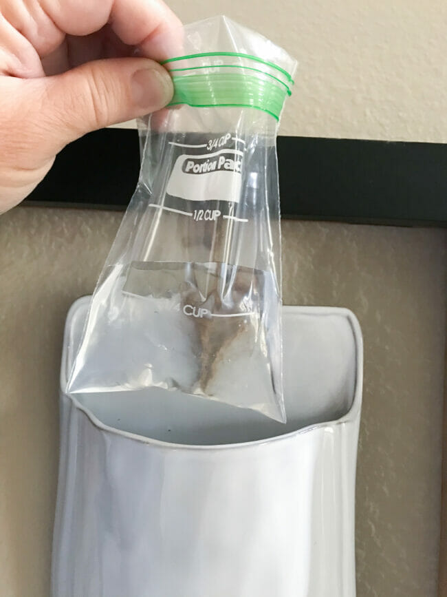 baggie with water being inserted into wall pocket