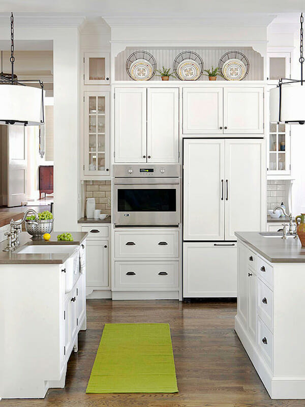 white kitchen with plates above cabinets