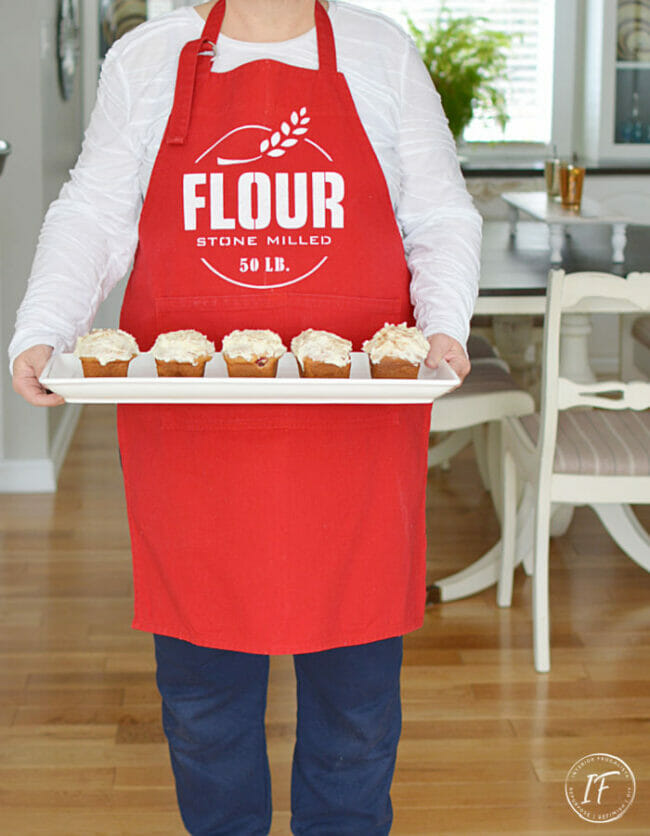 red flour apron with person holding cupcakes