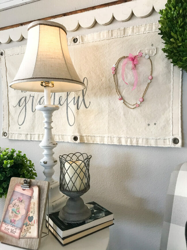 canvas wall art with valentine wreath and table with lamp