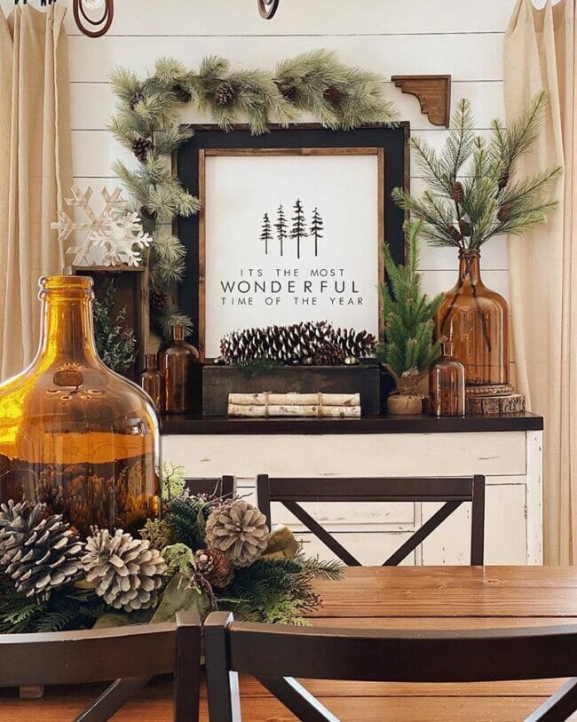brown bottles with greenery and pinecones
