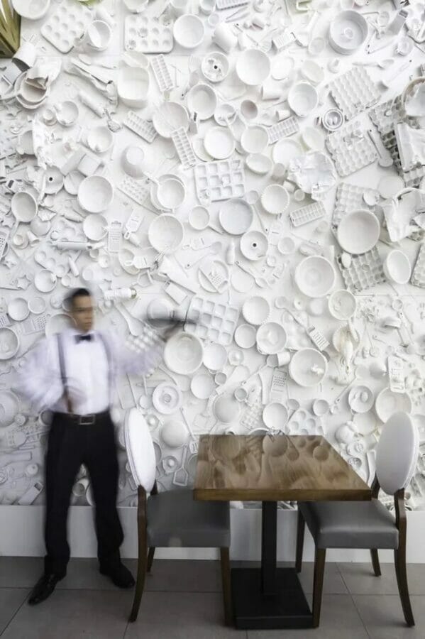 all white dish and utensils hanging as wall decor
