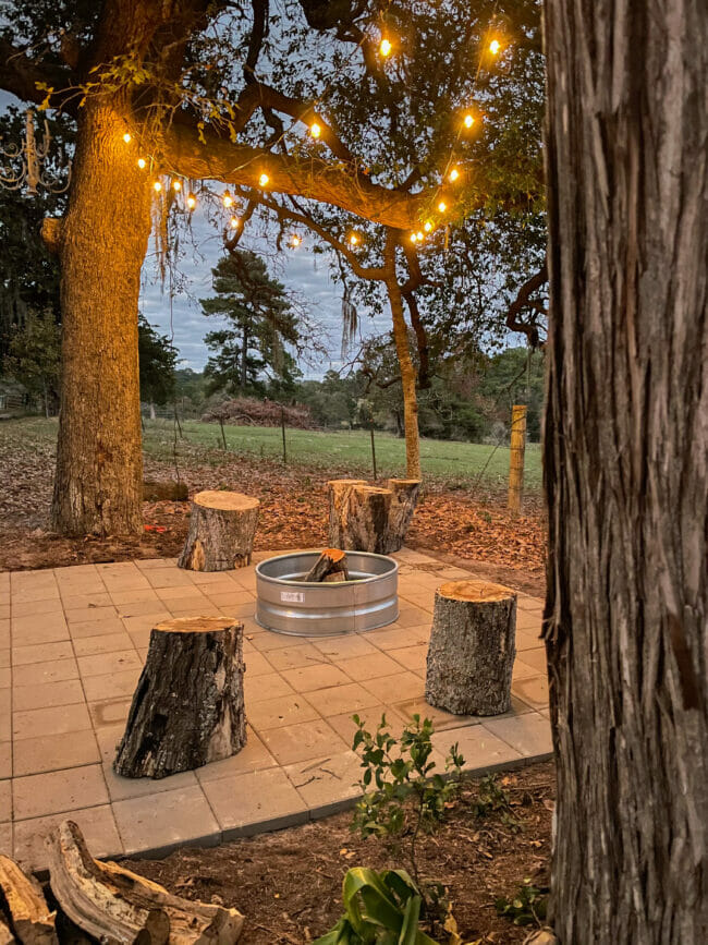 finished firepit with lights and logs for seating