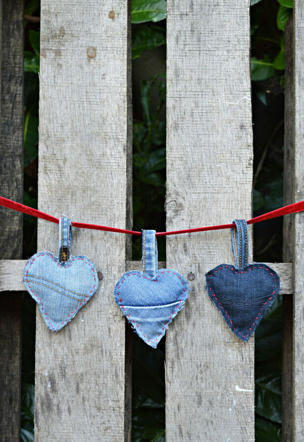 3 denim hearts hanging on fence