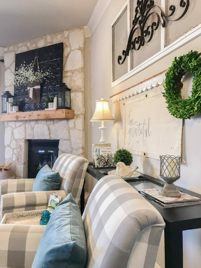 side view of checked chairs, mantel and sofa table